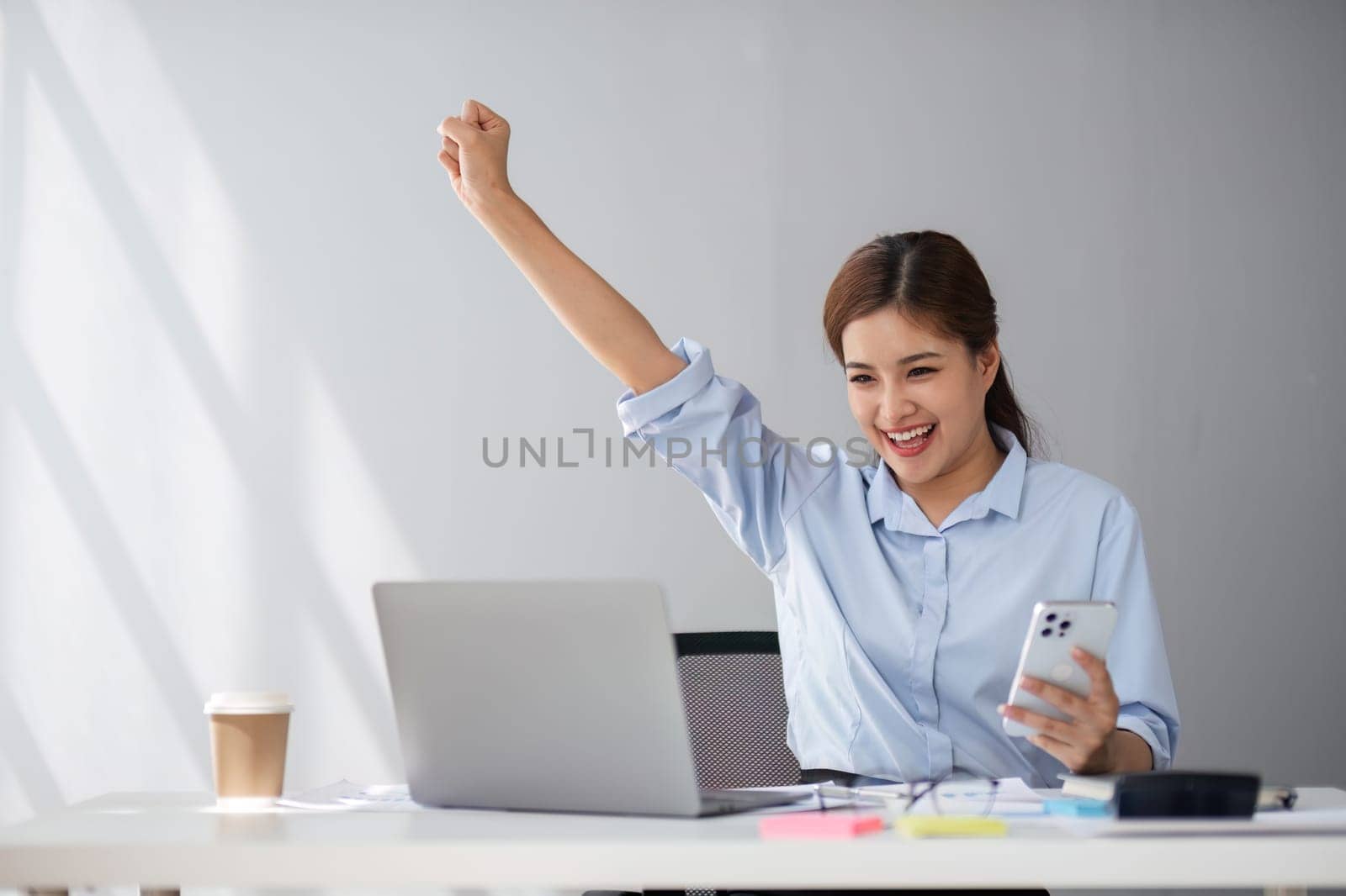 Happy middle-aged businesswoman working in the office. Businesswoman working on laptop and using in remote online job interview meeting on laptop. by wichayada