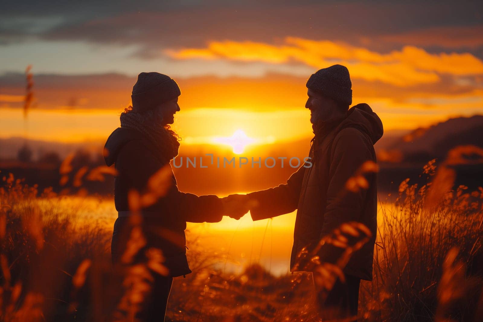 Silhouette of a couple admiring the sunset. High quality photo