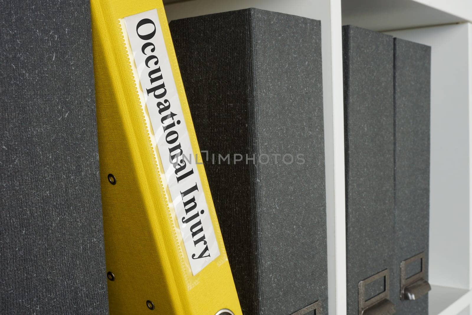 Yellow folder with reports about occupational injury on the shelf.