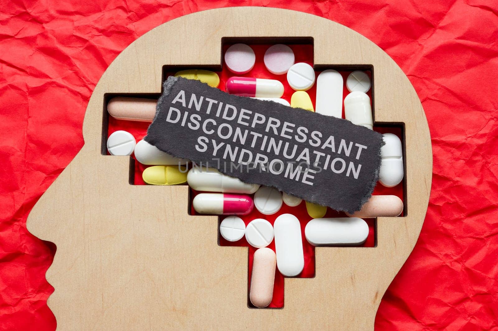 Head with pills and inscription antidepressant discontinuation syndrome. by designer491