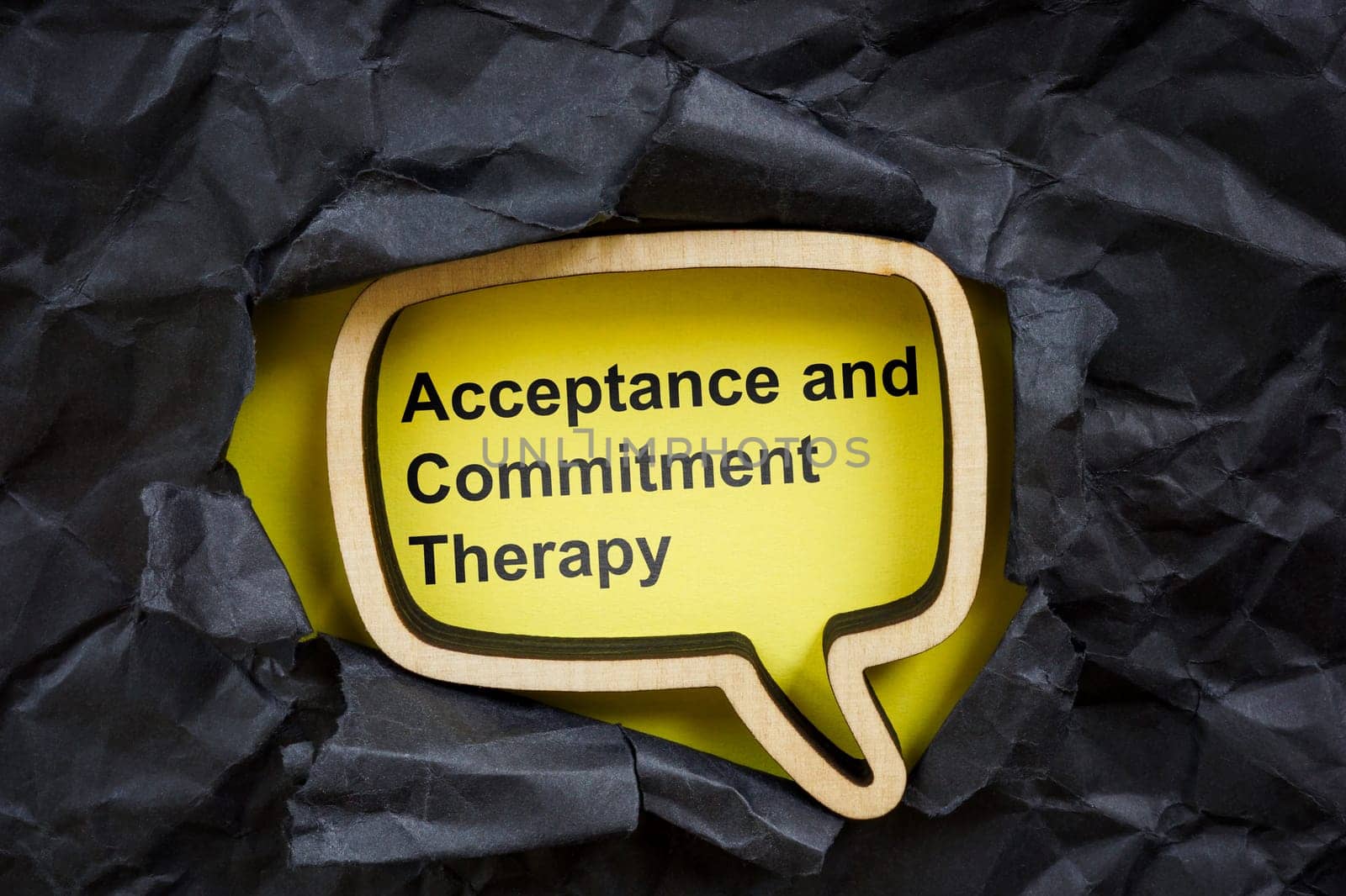 Acceptance and commitment therapy concept. Torn dark paper and speech bubble.