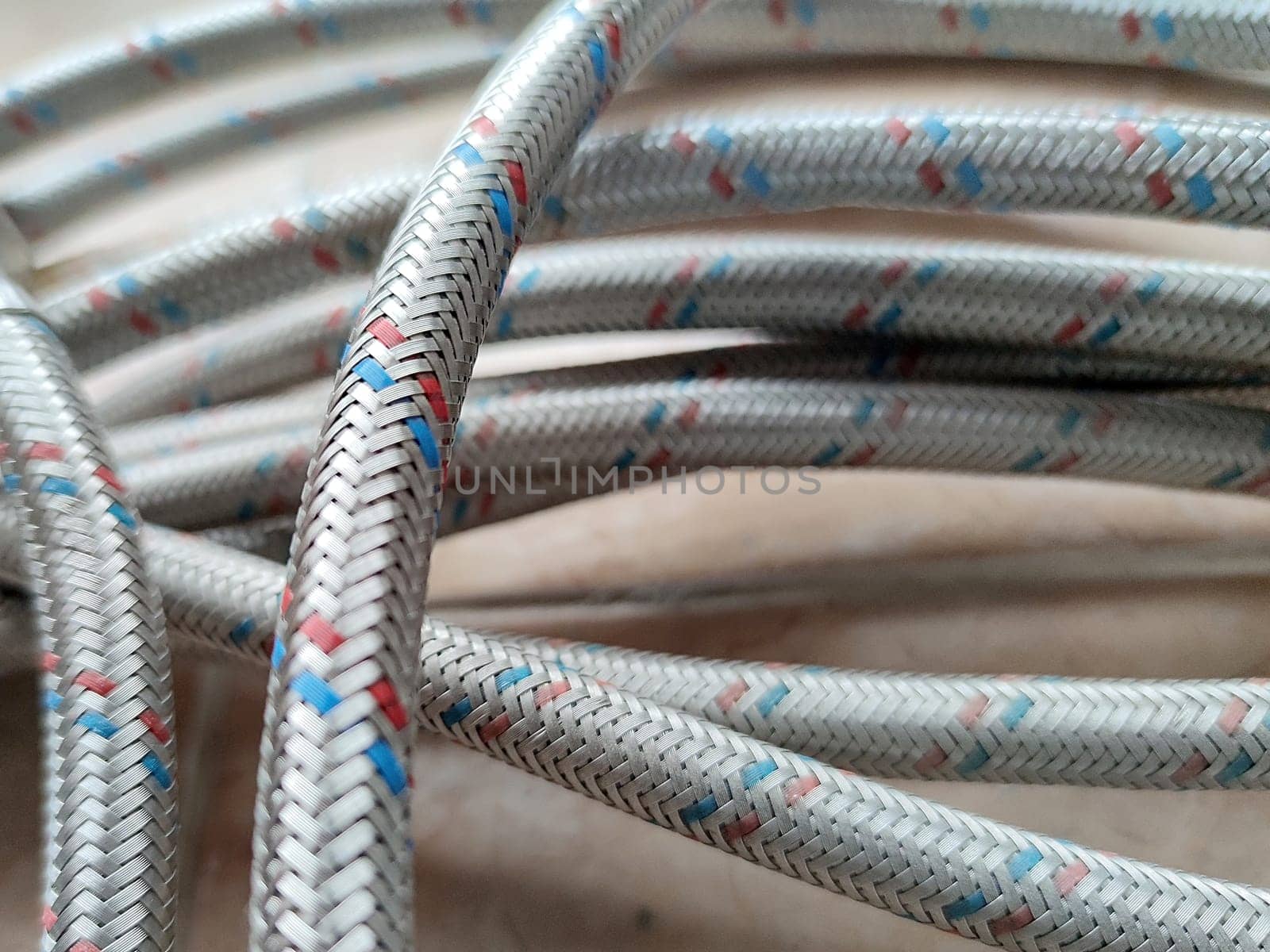 Water hoses in metal braid close up