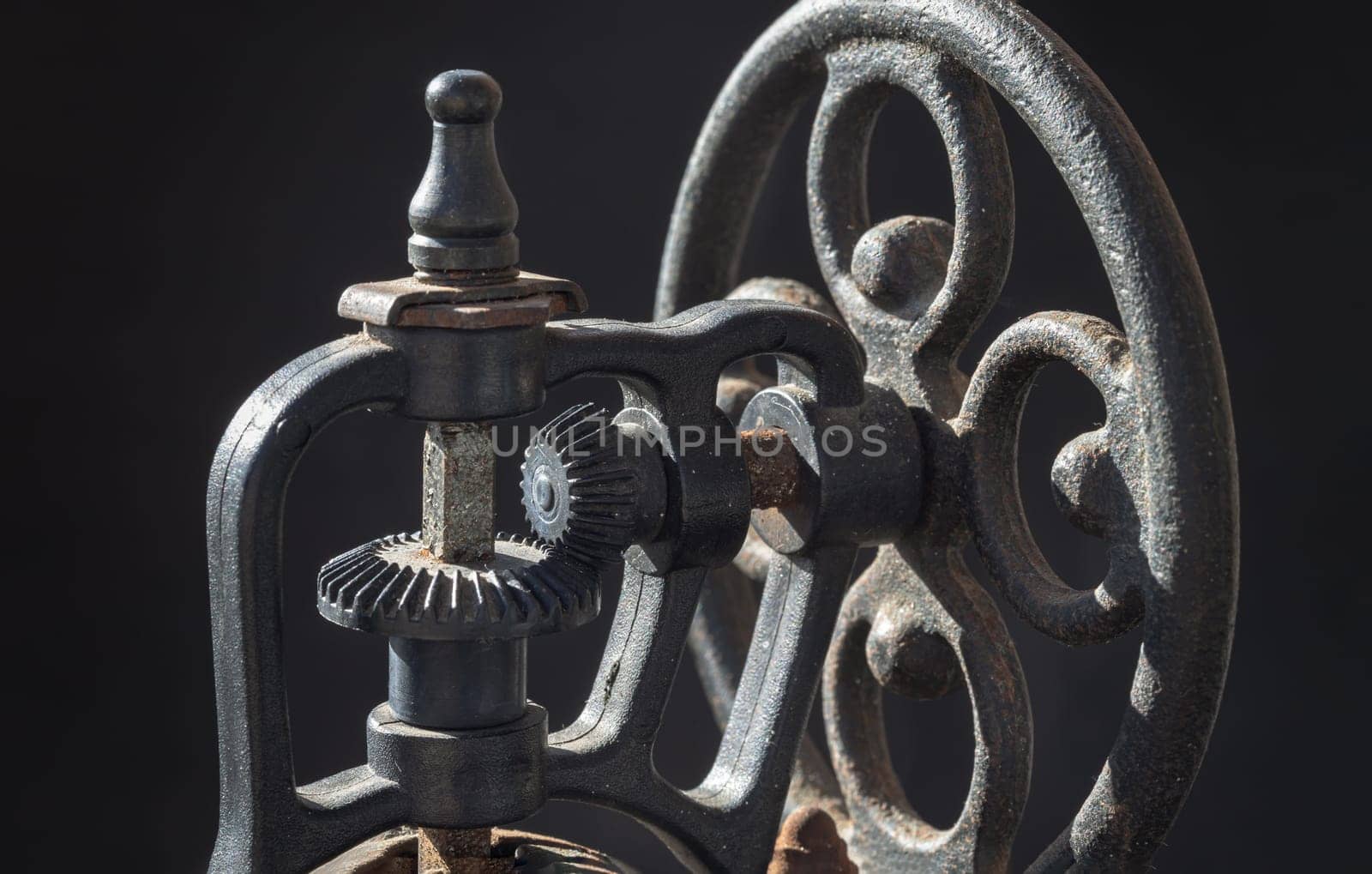 Detail of Antique coffee bean original grinder metal shake wheel with hand crank. Close-up of Old original coffee grinder, Space for text, Selective focus.