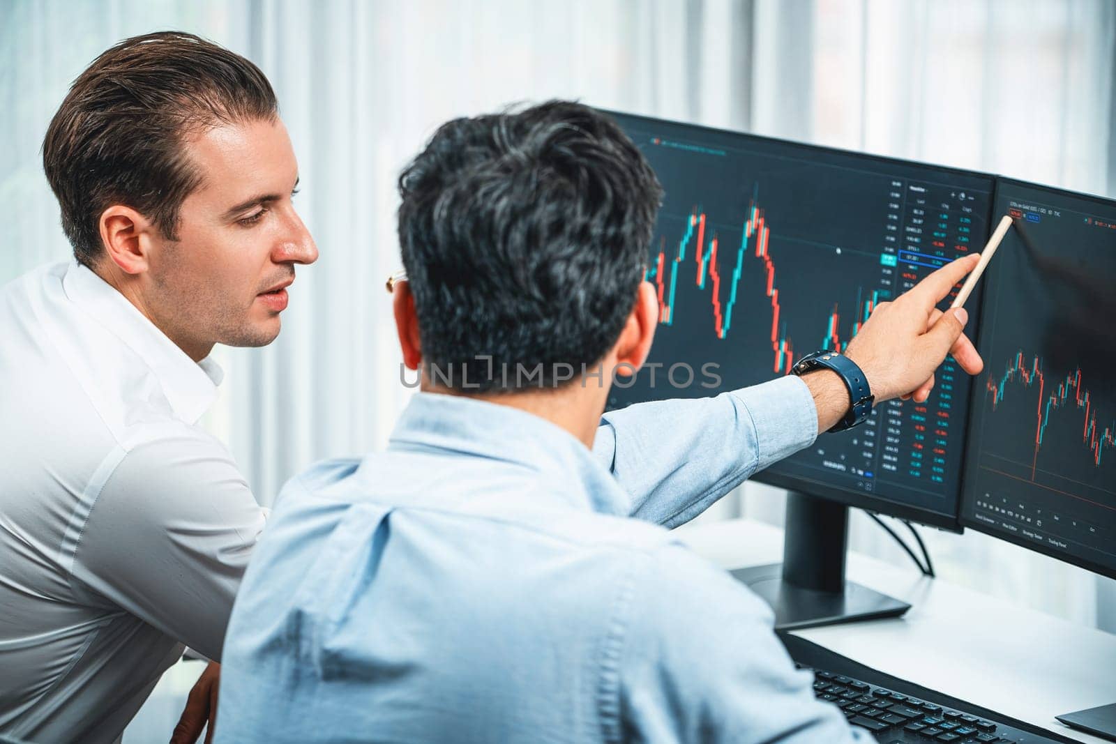 Investor stock office worker analyzing investment business trend on dynamic exchange rate database graph with monitor screen. Sharing information profit and loss in current situation crisis. Sellable.