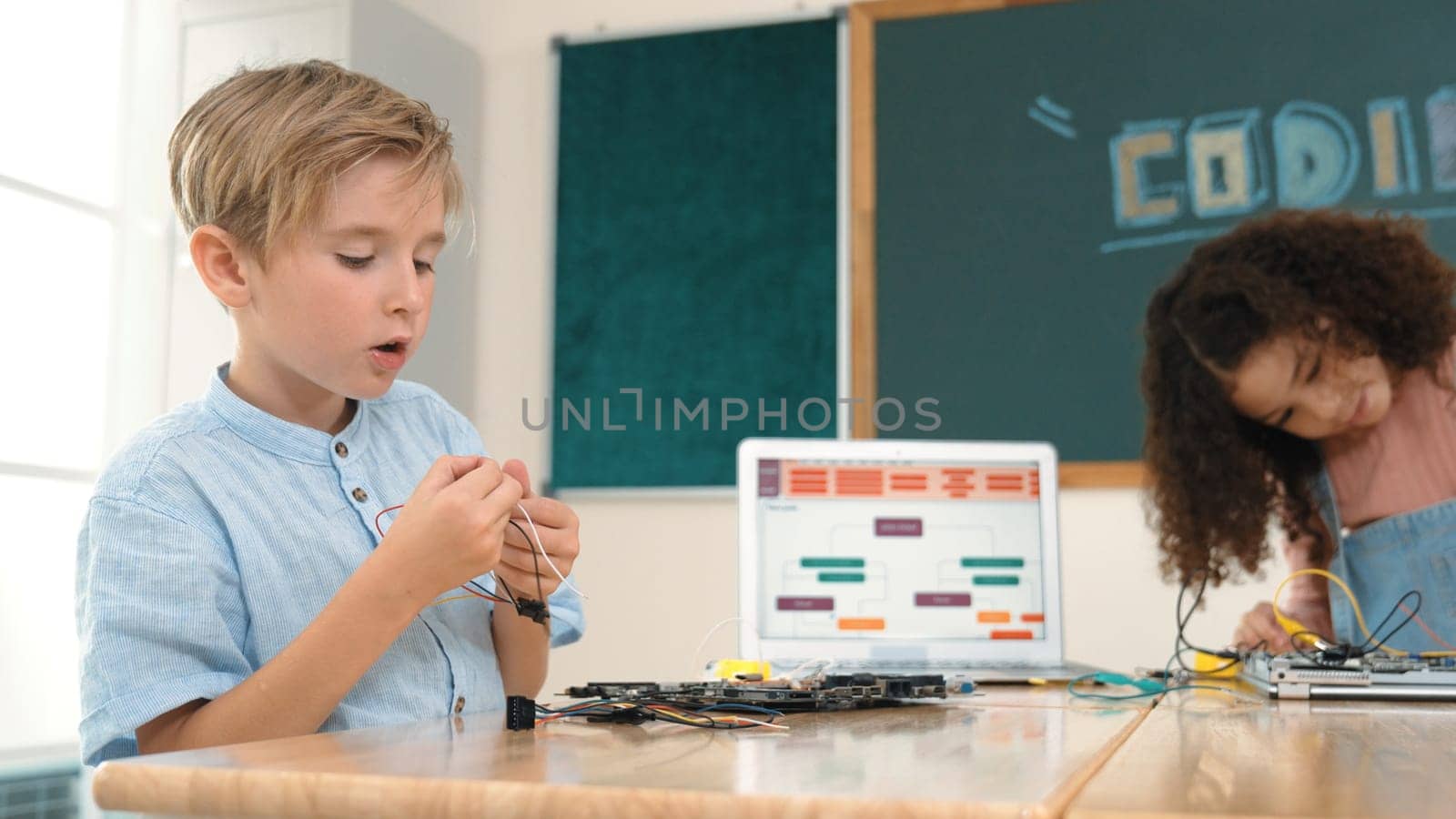 Girl standing while fixing electronic board by using screwdriver. Pedagogy. by biancoblue