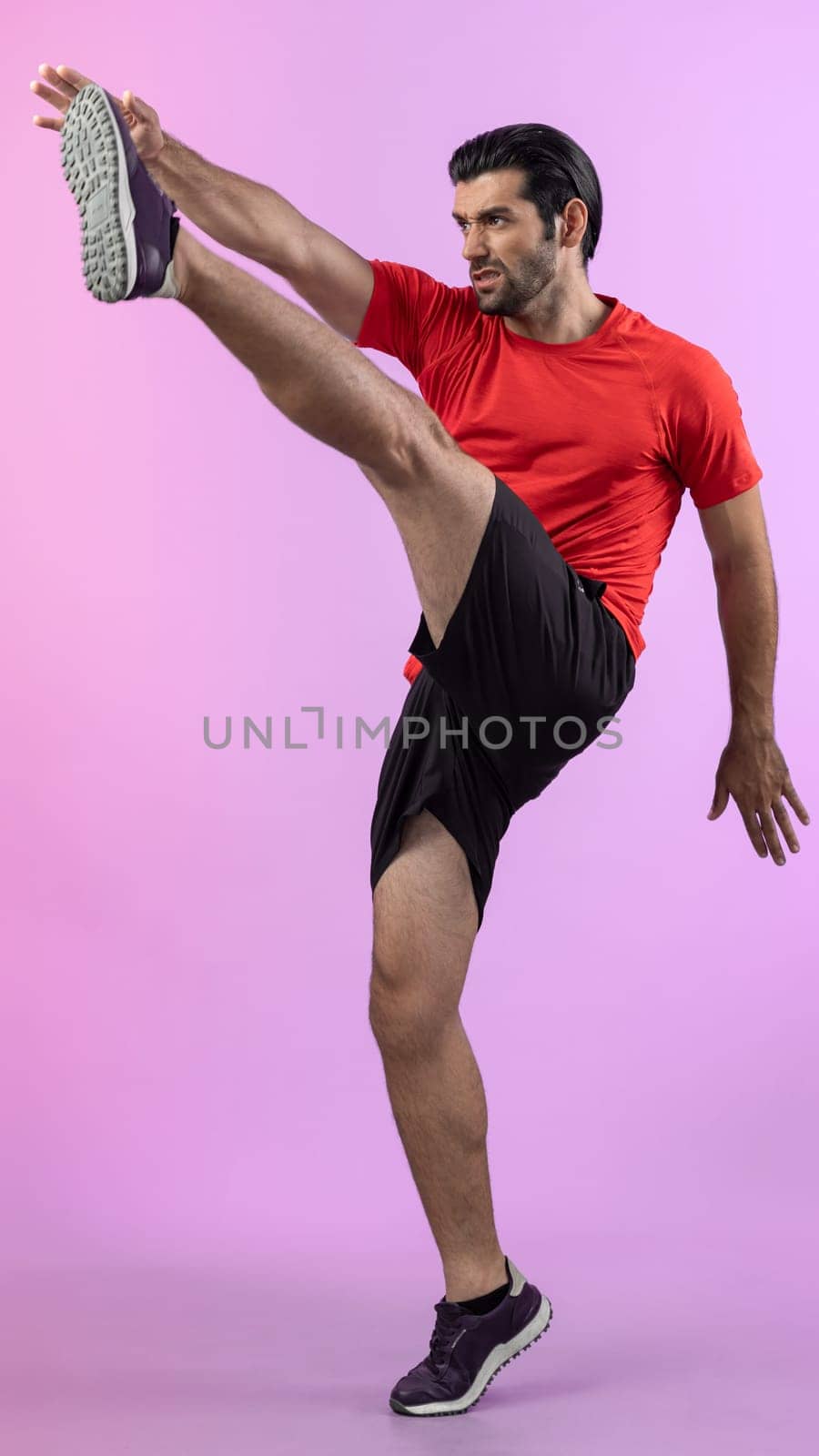 Full body length gaiety shot athletic and sporty young man with fitness in cardio exercise, kicking position posture on isolated background. Healthy active and body care lifestyle.