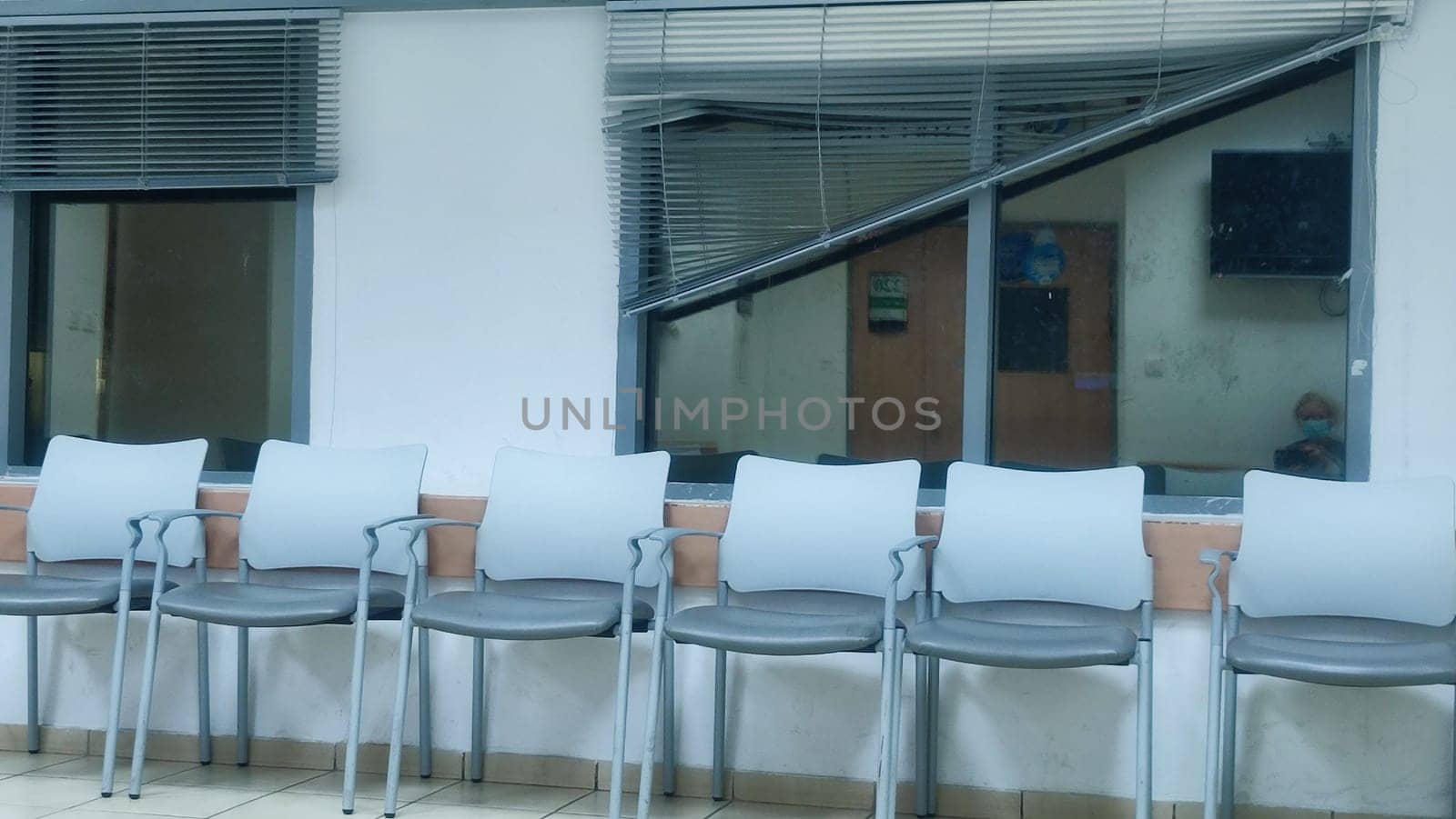 gray office chairs in the hallway near the windows, doors and tris. High quality photo