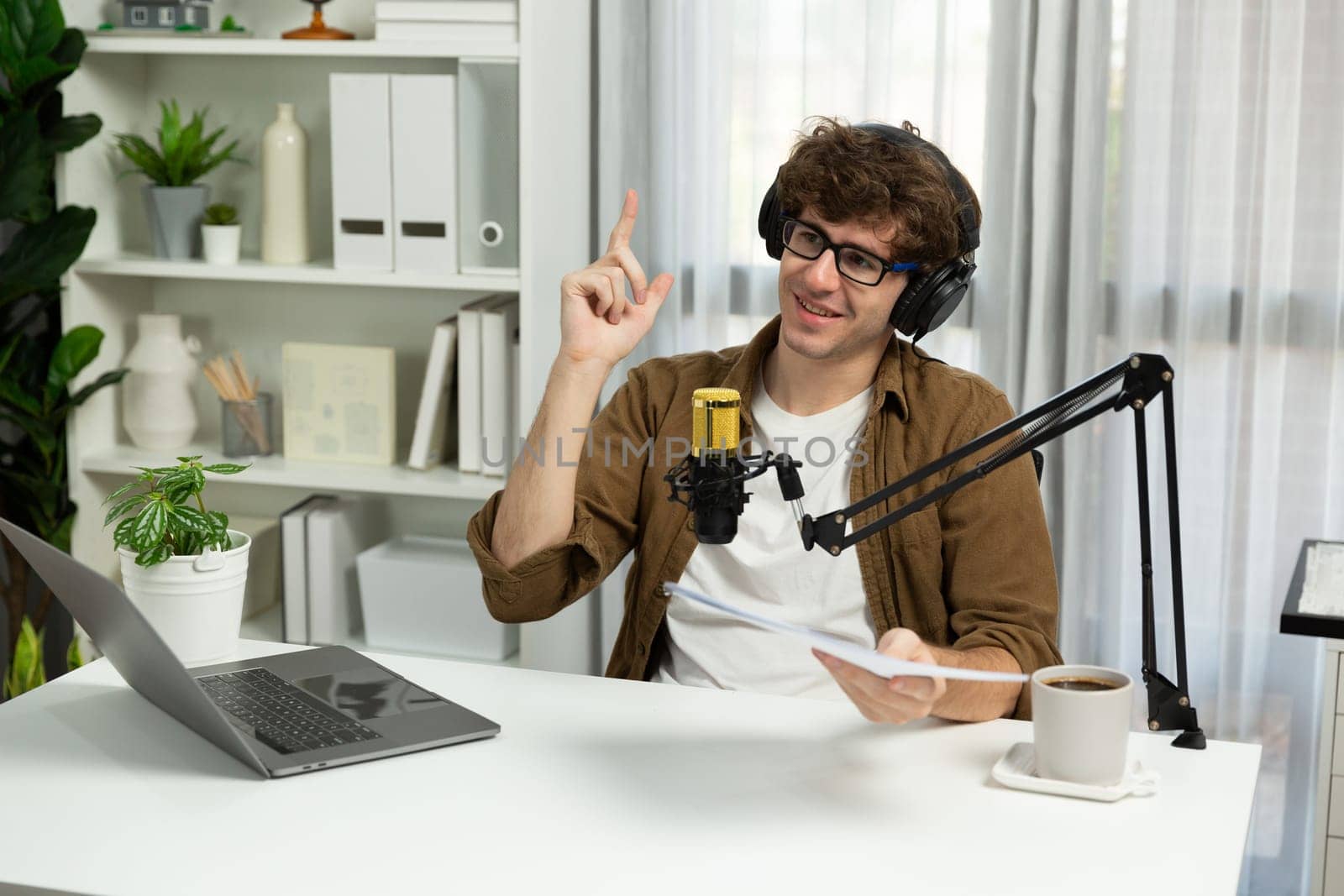 Host channel of influencer reading question script with listeners on social media with laptop in life coaching. Concept of radio online for consulting lifestyles at cozy studio modern office. Gusher.