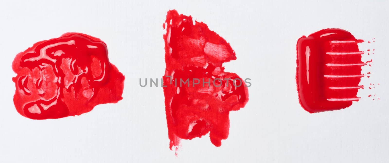 Watercolor brush stroke of red paint on a white isolated background by ndanko