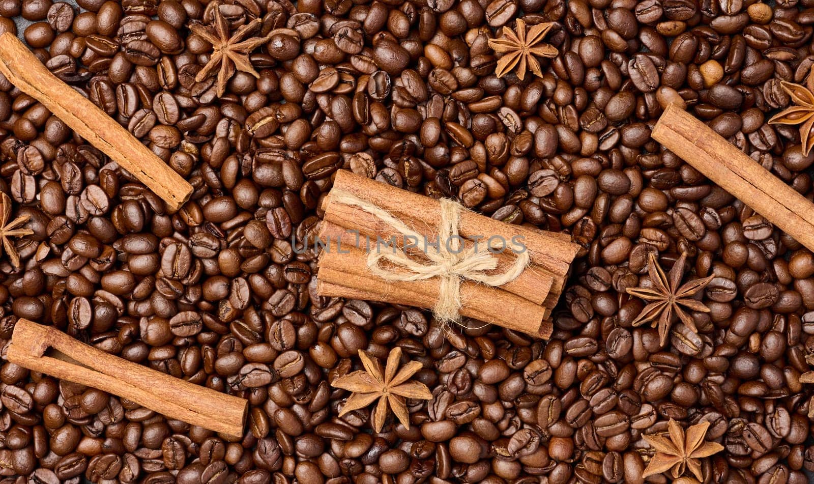 Roasted coffee beans, cinnamon sticks and star anise, full frame by ndanko