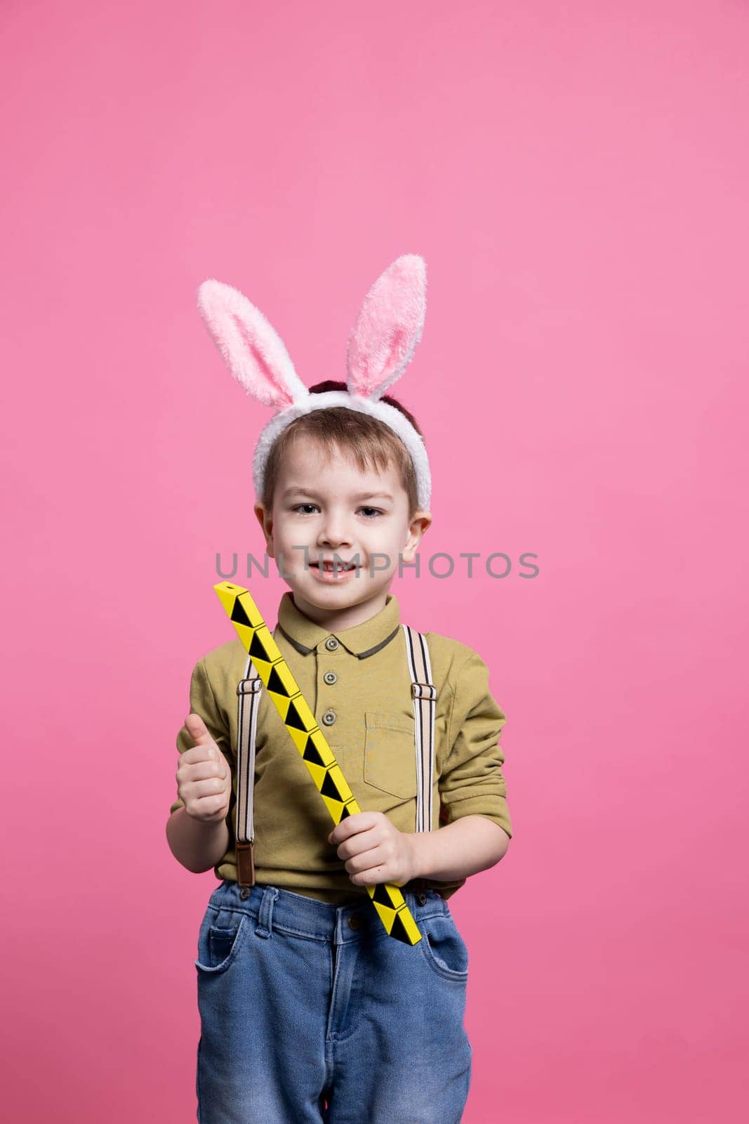 Young cute toddler playing around with a toy in front of camera by DCStudio