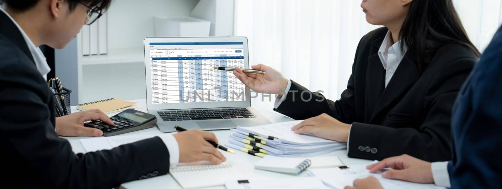 Corporate accountant team use accounting software on laptop to calculate and maximize tax refund and improve financial performance base on financial data. Modern business accounting . Shrewd