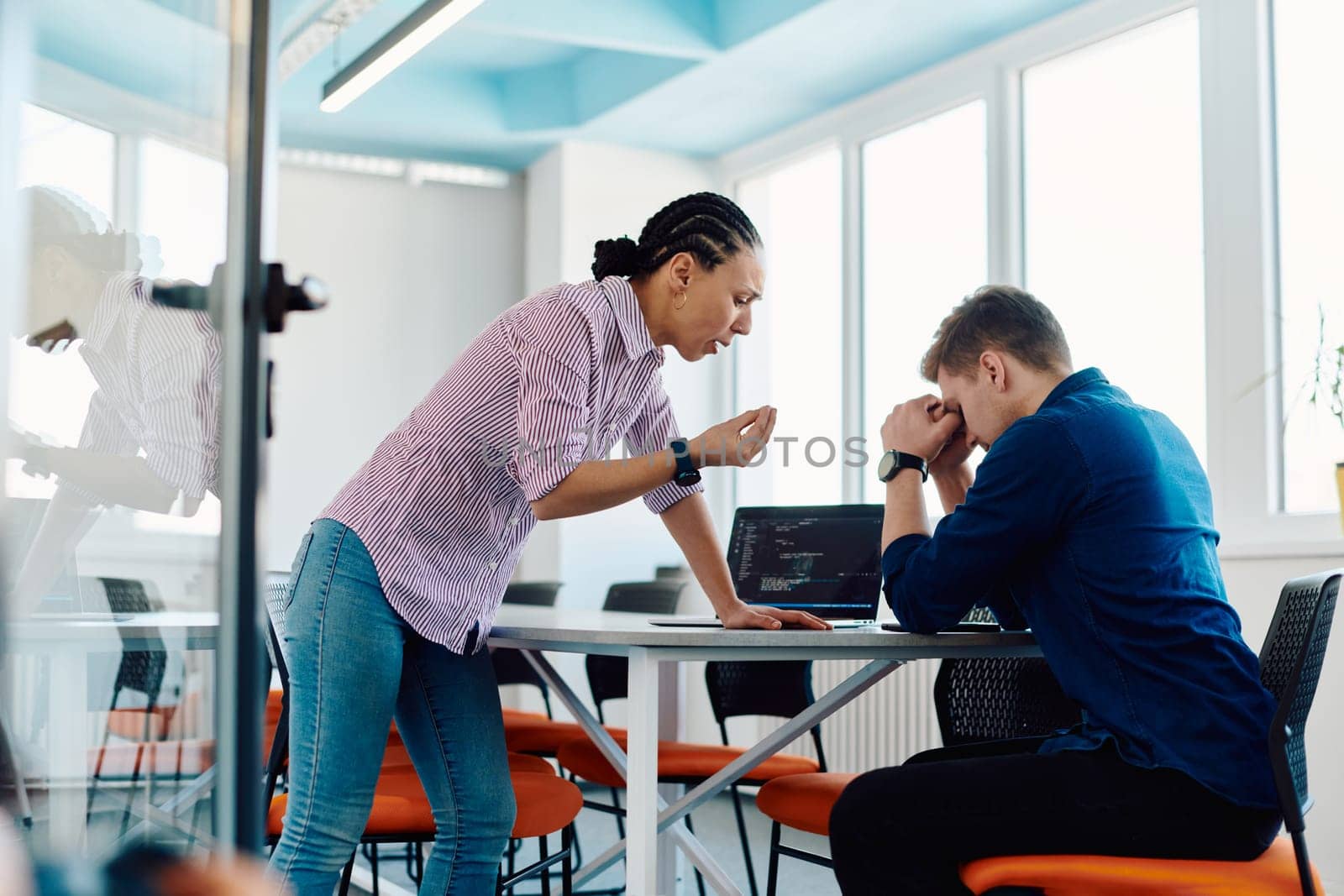 A furious business director of a startup office berating her employee for business mistakes and errors.