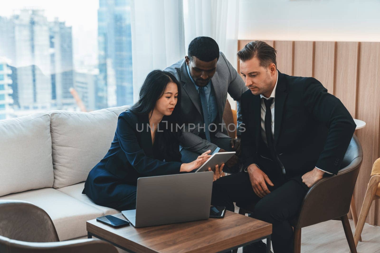 Group of skilled multiethnic businesspeople looking at data analysis by using tablet. Group of smart manager sharing, brainstorming, discussing, thinking about marketing strategy, idea. Ornamented