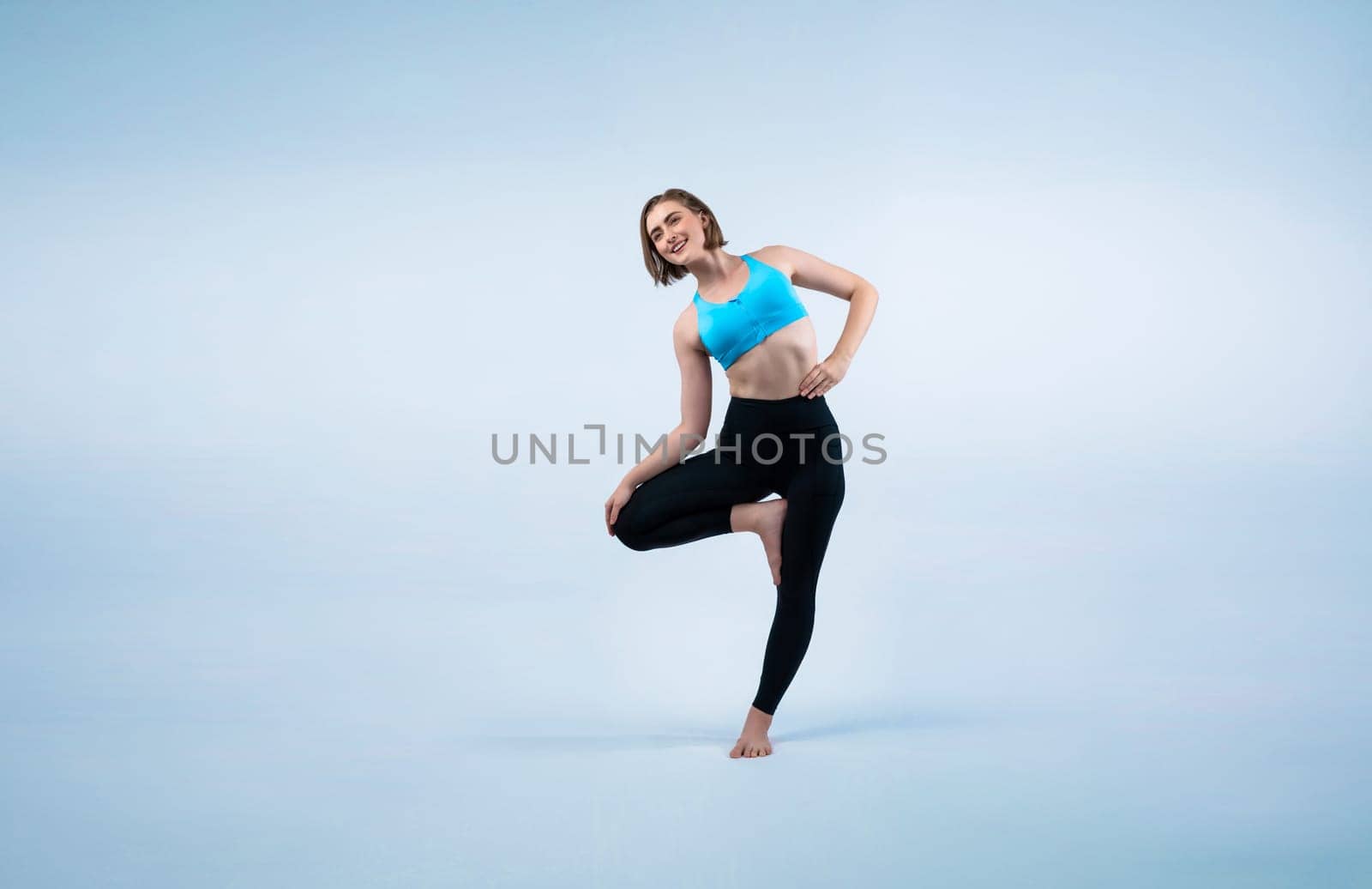 Full body length gaiety shot athletic and sporty woman doing healthy and meditative yoga exercise workout posture on isolated background. Healthy active and body care lifestyle