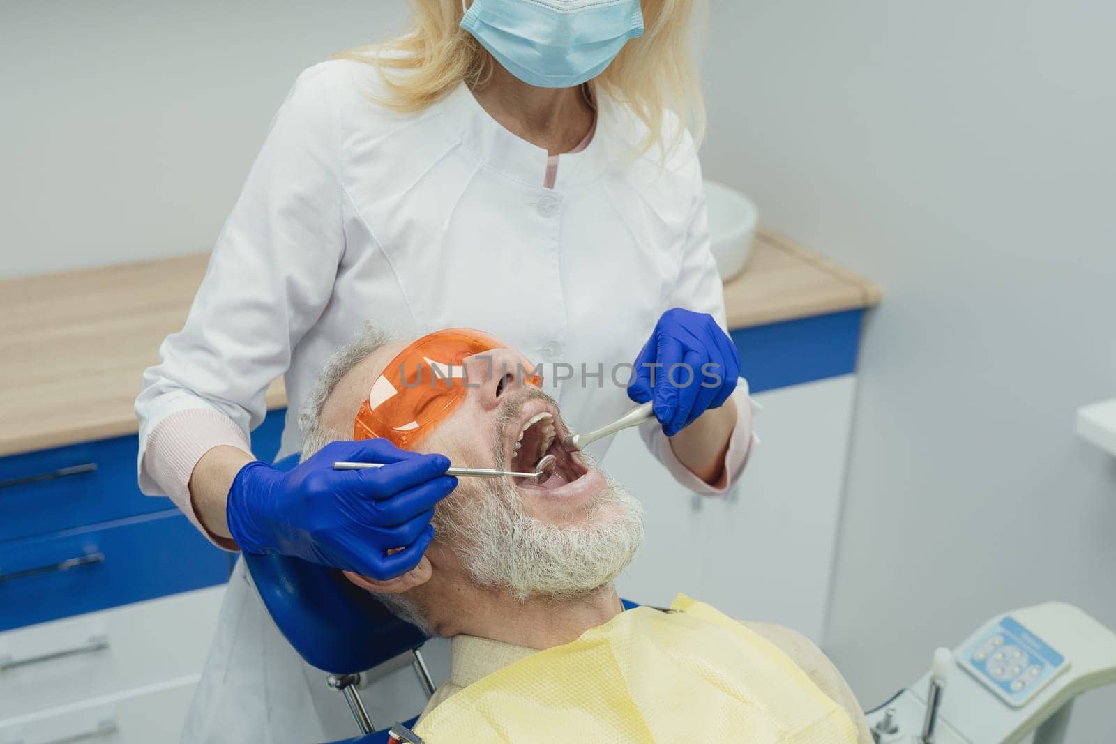 Male smiling during her dental treatment at dentist.