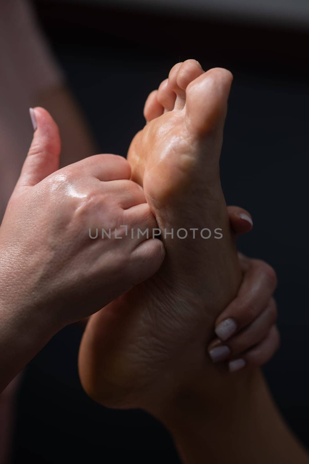 Close-up of a woman's foot massage. Vertical photo. by mrwed54