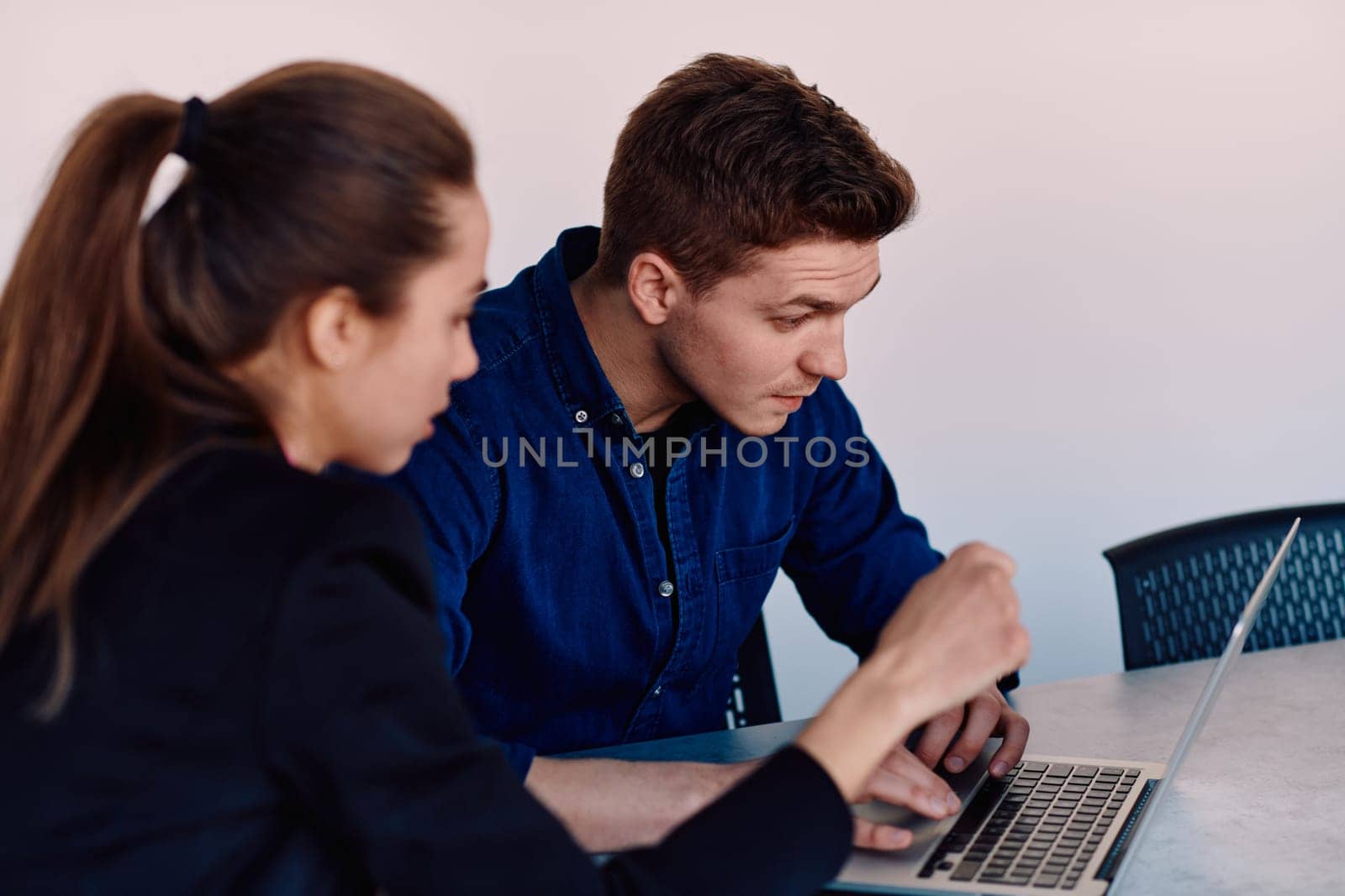 A business leader in a suit conversing with her worker in the IT industry about new business projects and existing business problems by dotshock