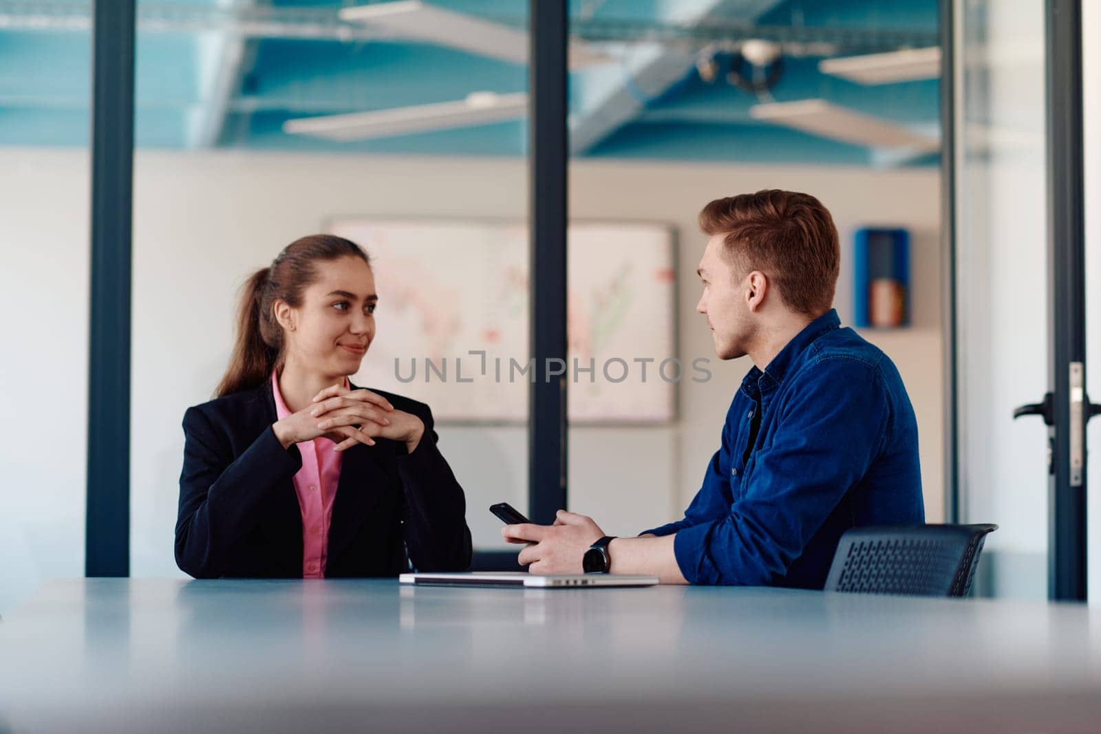 A business leader in a suit conversing with her worker in the IT industry about new business projects and existing business problems by dotshock
