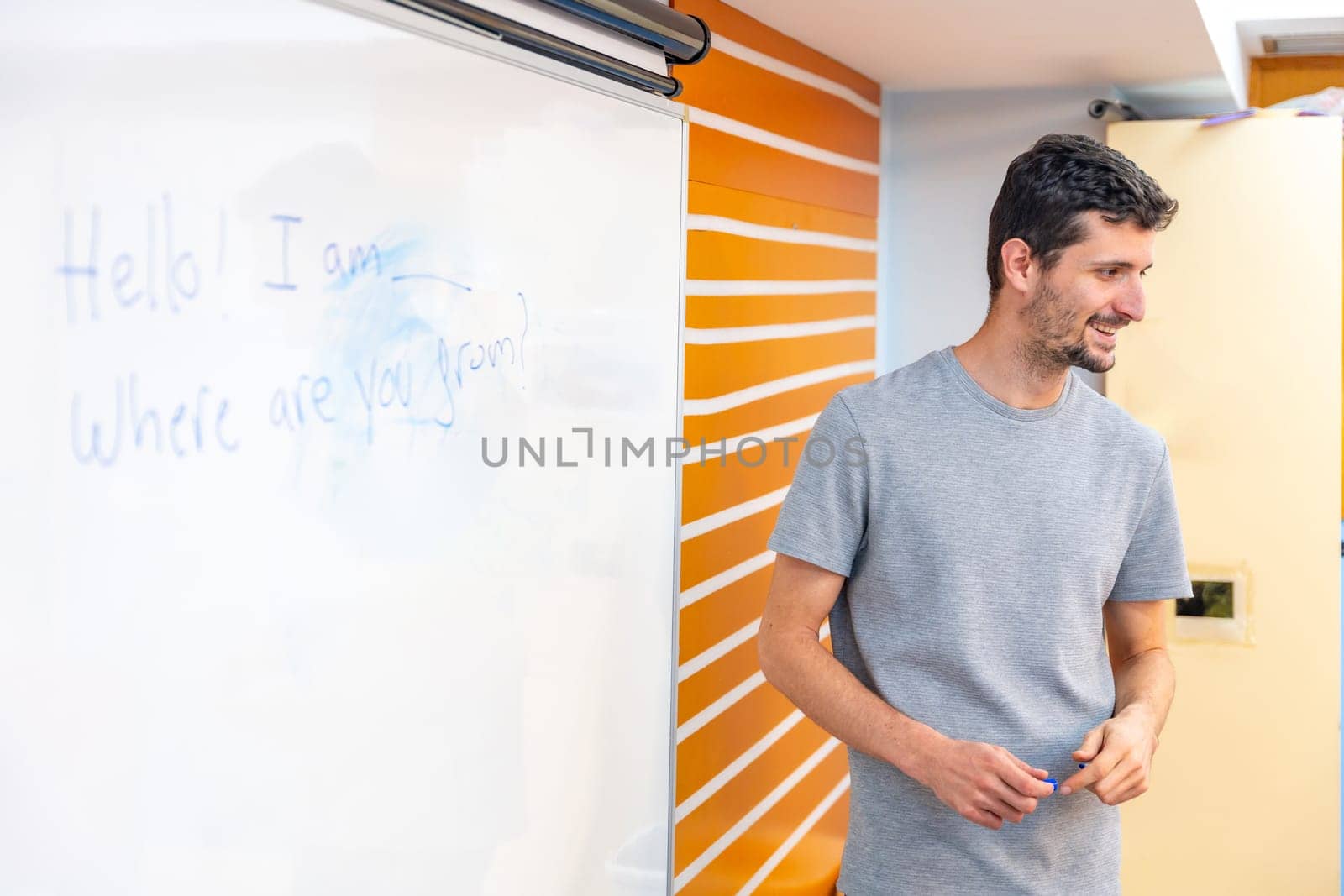 Teacher using white board during a IT computer class with disabled people