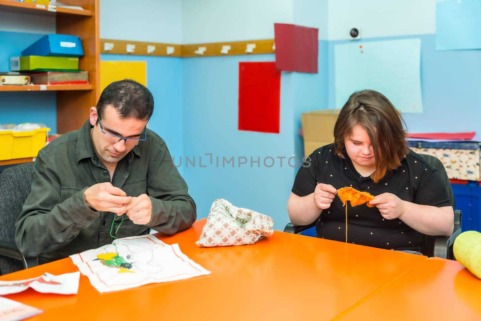 People with intellectual disabilities knitting clothes with wool by Huizi