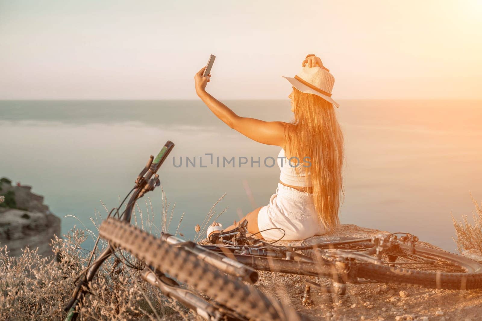 Selfie woman in cap and tank top making selfie shot mobile phone post photo social network outdoors on sea background beach people vacation lifestyle travel concept