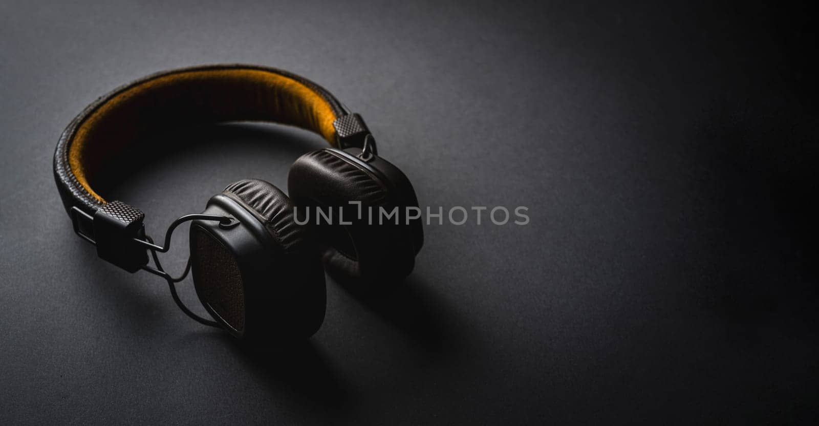 Retro style wireless over-ear headphones on dark gray background