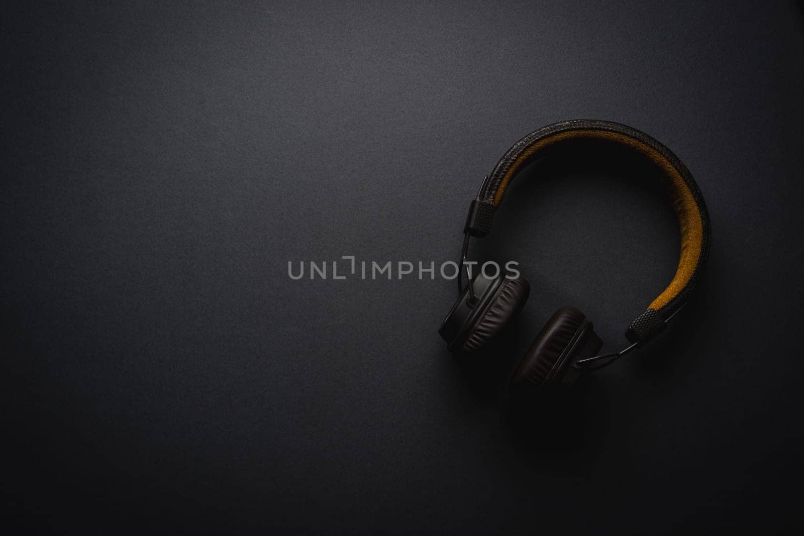 Retro style wireless over-ear headphones on dark gray background by Sonat