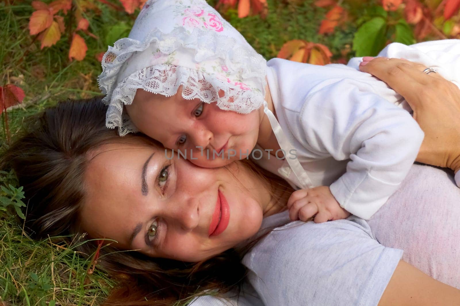 Young pretty mother with a cute breast newborn baby in a sunny forest by jovani68