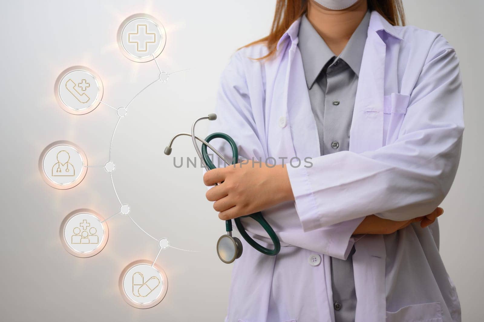 An unrecognizable doctor holding stethoscope standing on white background. Medical technology and health care concept.