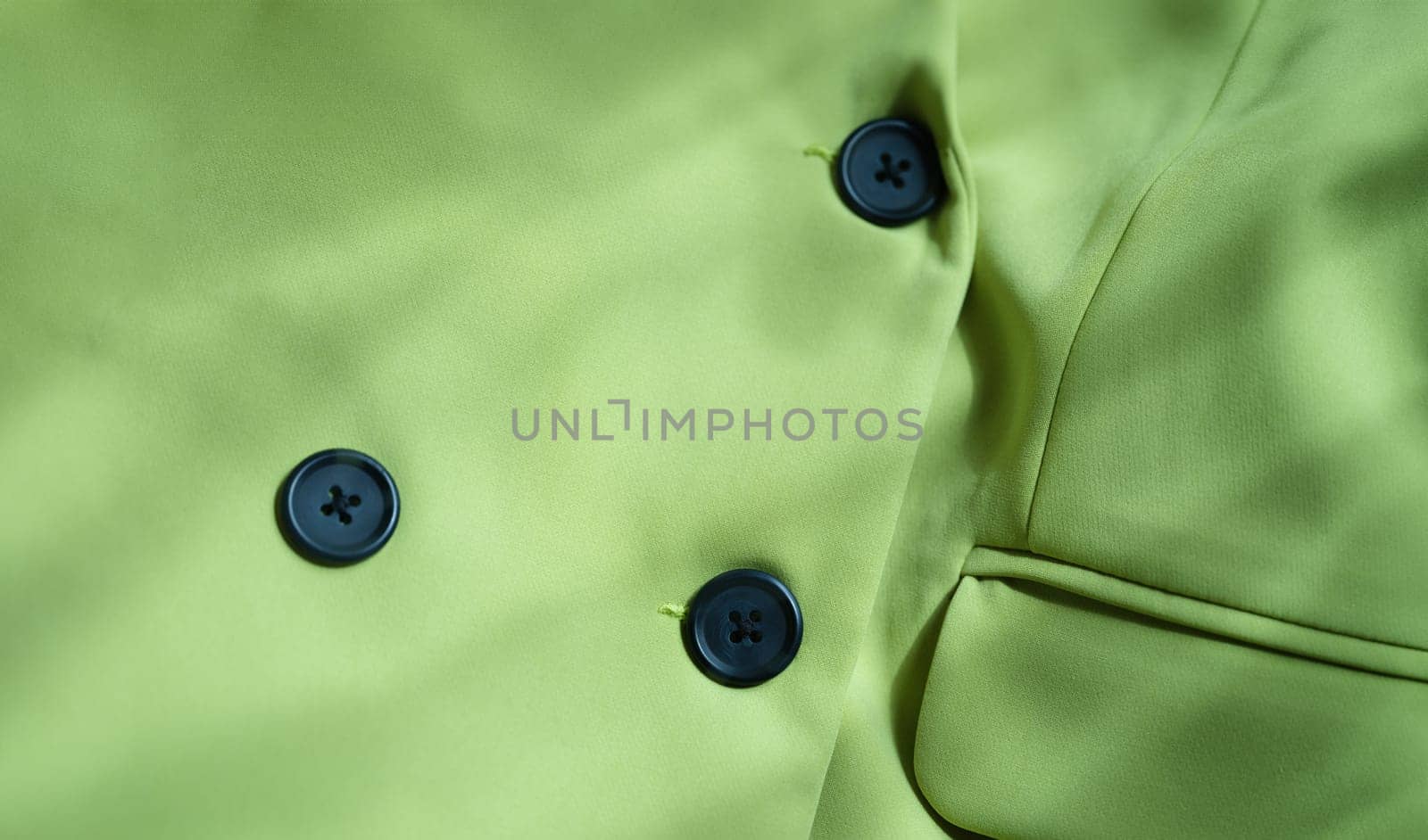 Closeup of custom made green jacket with black buttons by kuprevich