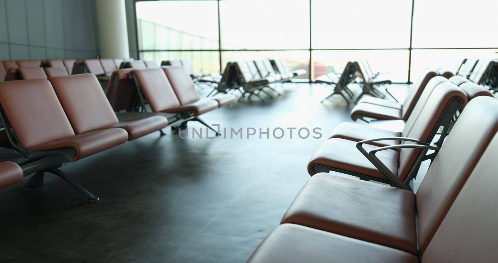 Empty terminal at airport waiting area at gate and air business. Brown leather chair at airport