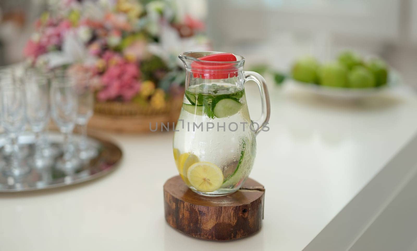 Fruit water with lemon lime cucumber and mint in glass jug by kuprevich