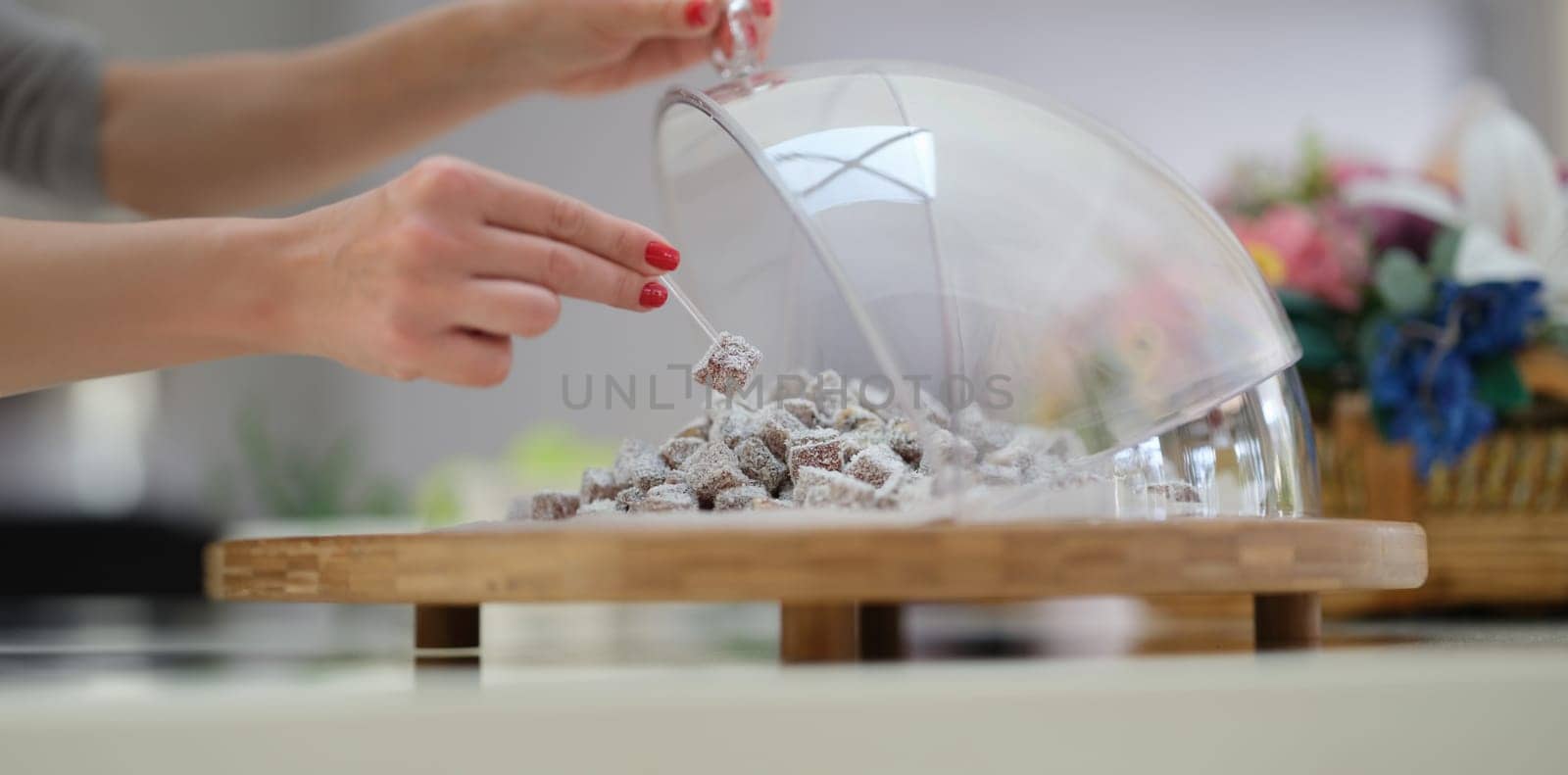 Hand selection of Turkish delight with coconut and pistachios on table. by kuprevich