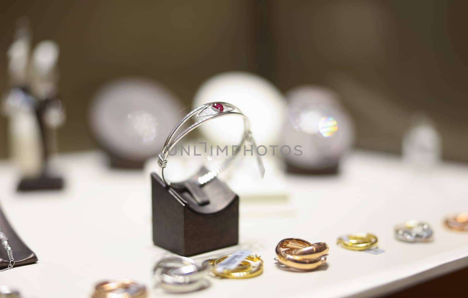White gold ring with ruby on shop window closeup by kuprevich