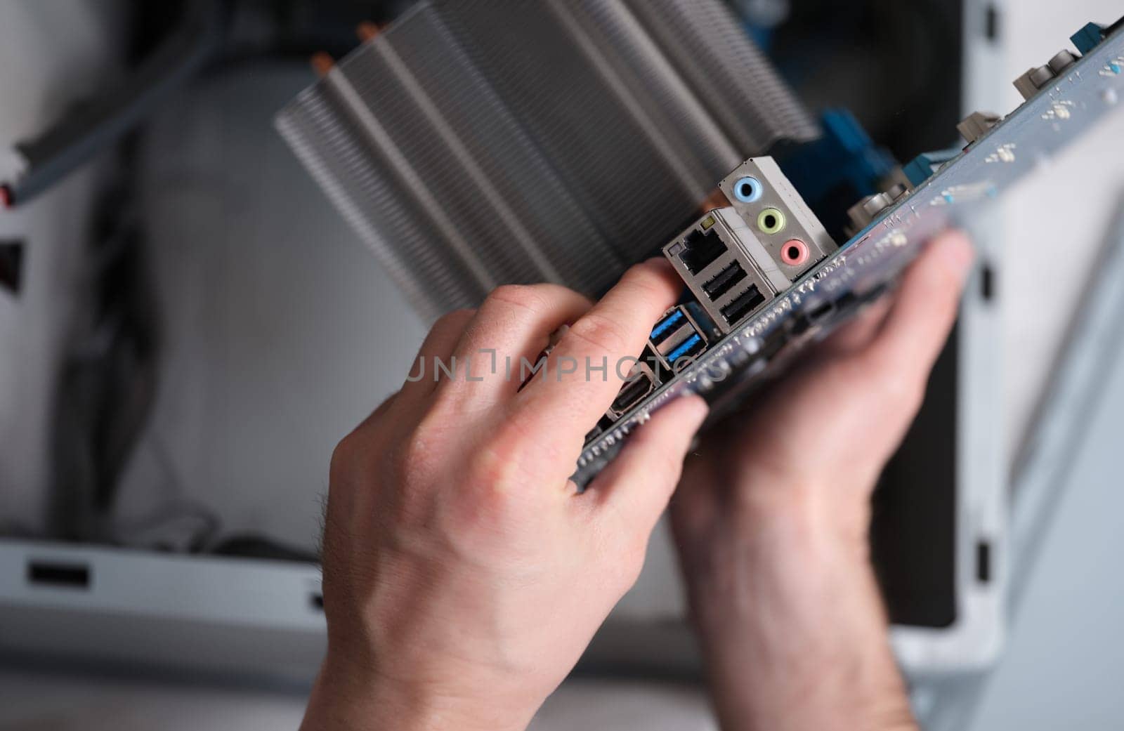 Motherboard hand holder port in laptop computer closeup. Computer equipment repair concept