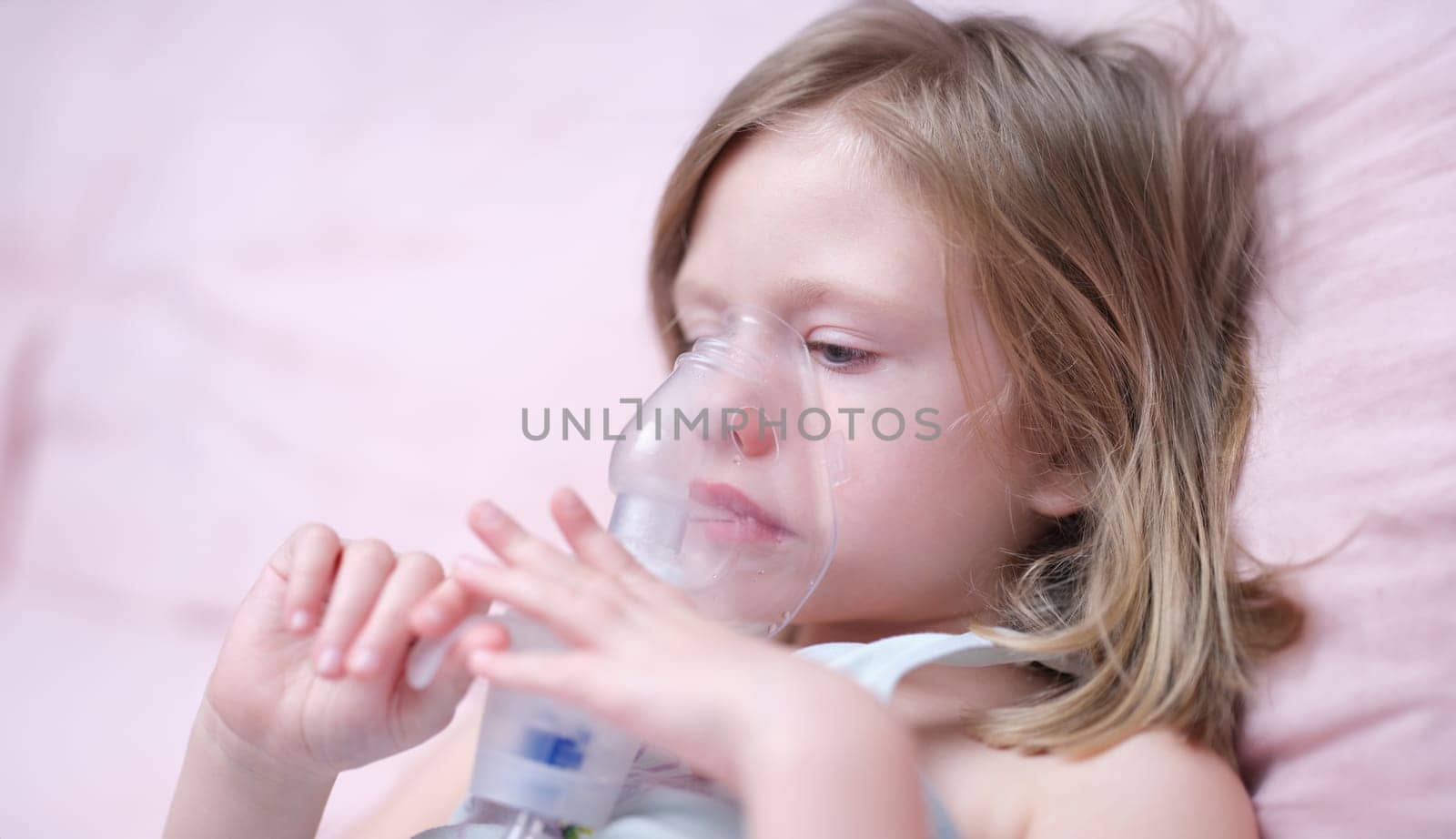 Portrait of child girl with inhaler for asthma. Oxygen mask for children concept