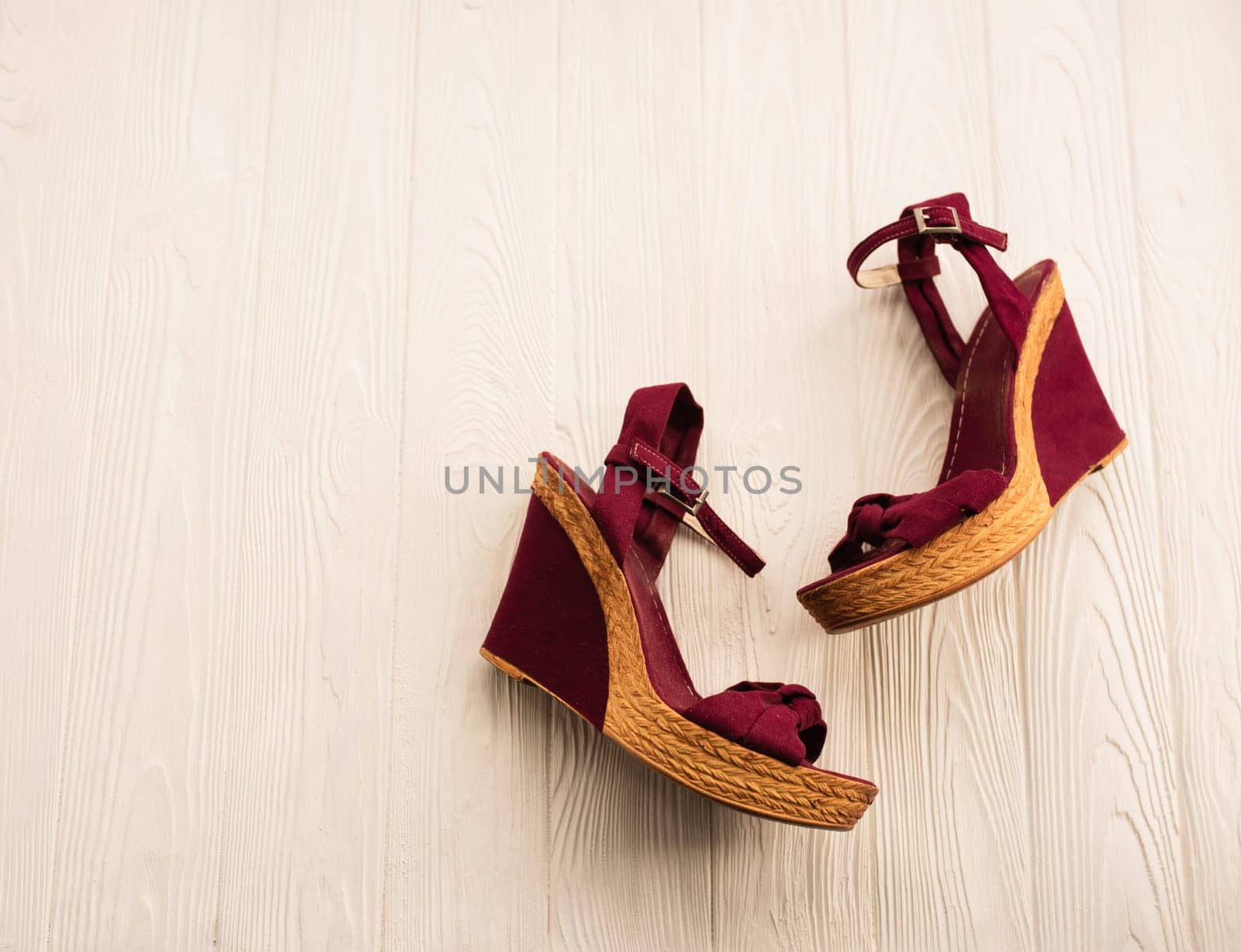 Stylish wedge shoes burgundy footwear clothing. Summer background mockup text. pattern top view above white wooden background. Summer fashion accessories beach. Women summer Vacation top view concept