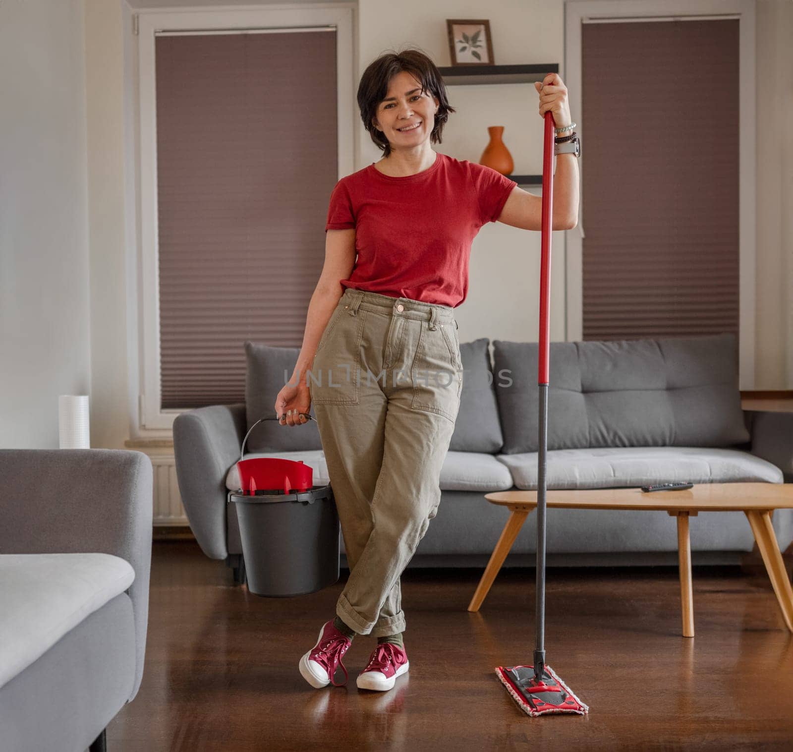 Cheerful Cleaner Stands In Room With Mop And Bucket, Washing Floor