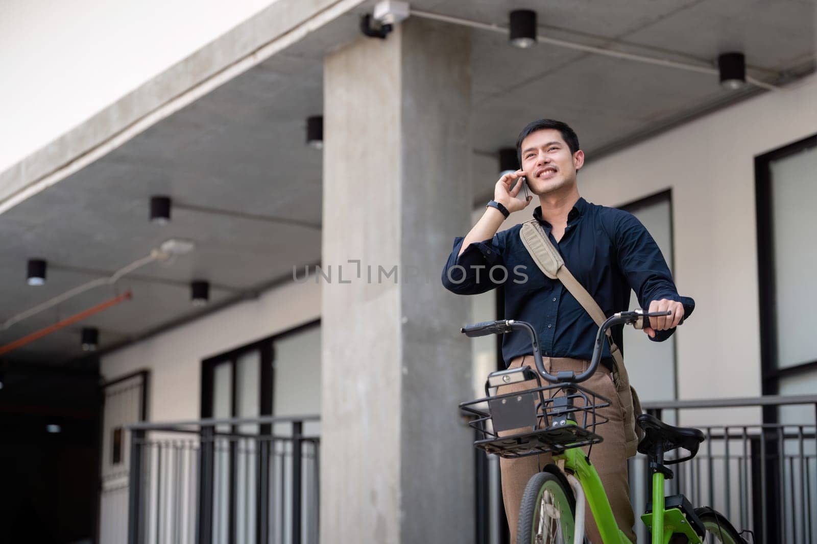 Businessman and bicycle in city to work with eco friendly transport. bike and happy businessman professional talking, speaking and telephone discussion while on in urban street by nateemee