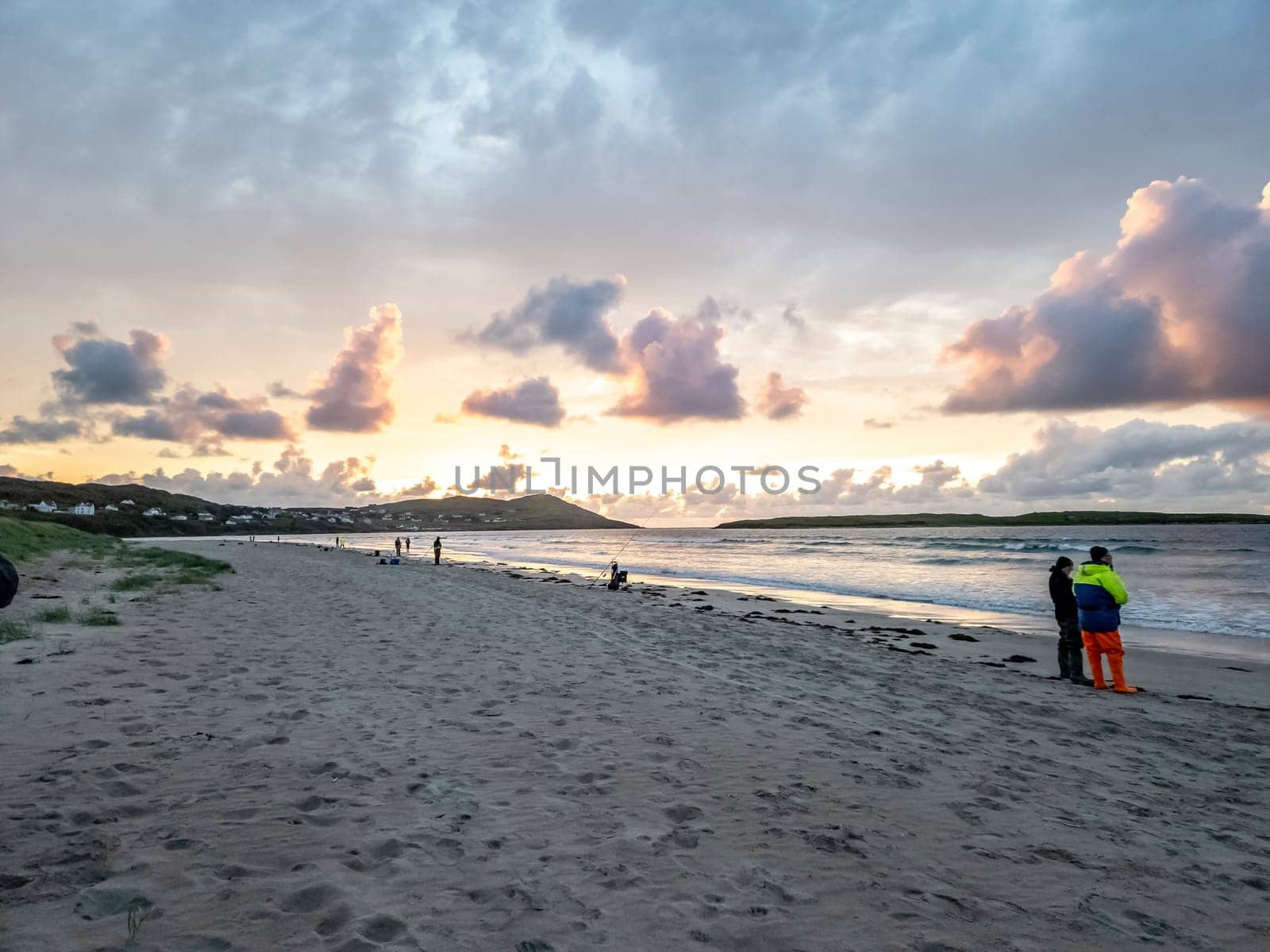 20 man are competing in a fishing competition on the beach