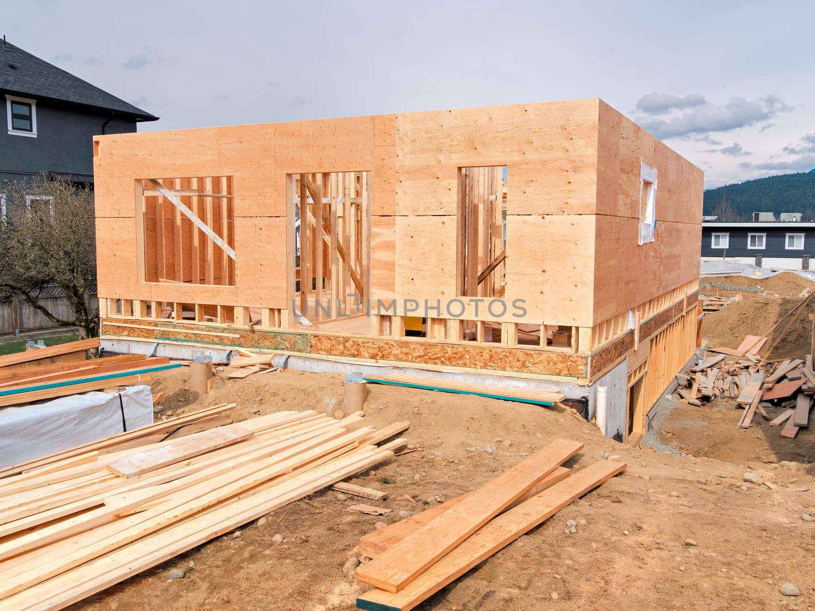 Wooden frame of a new house with engineered lumber materials in front by Imagenet