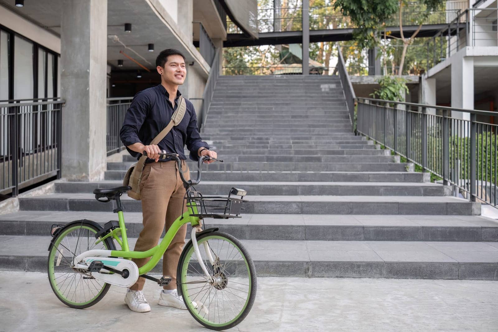 Young Asian businessman Go to work by cycling to reduce air pollution and stay healthy. by wichayada