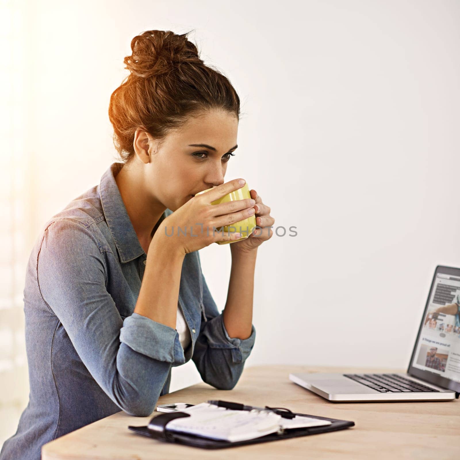 Businesswoman, office and thinking and drinking coffee, laptop for digital technology planning or web development. Networking and communication for social media, internet research or design idea by YuriArcurs