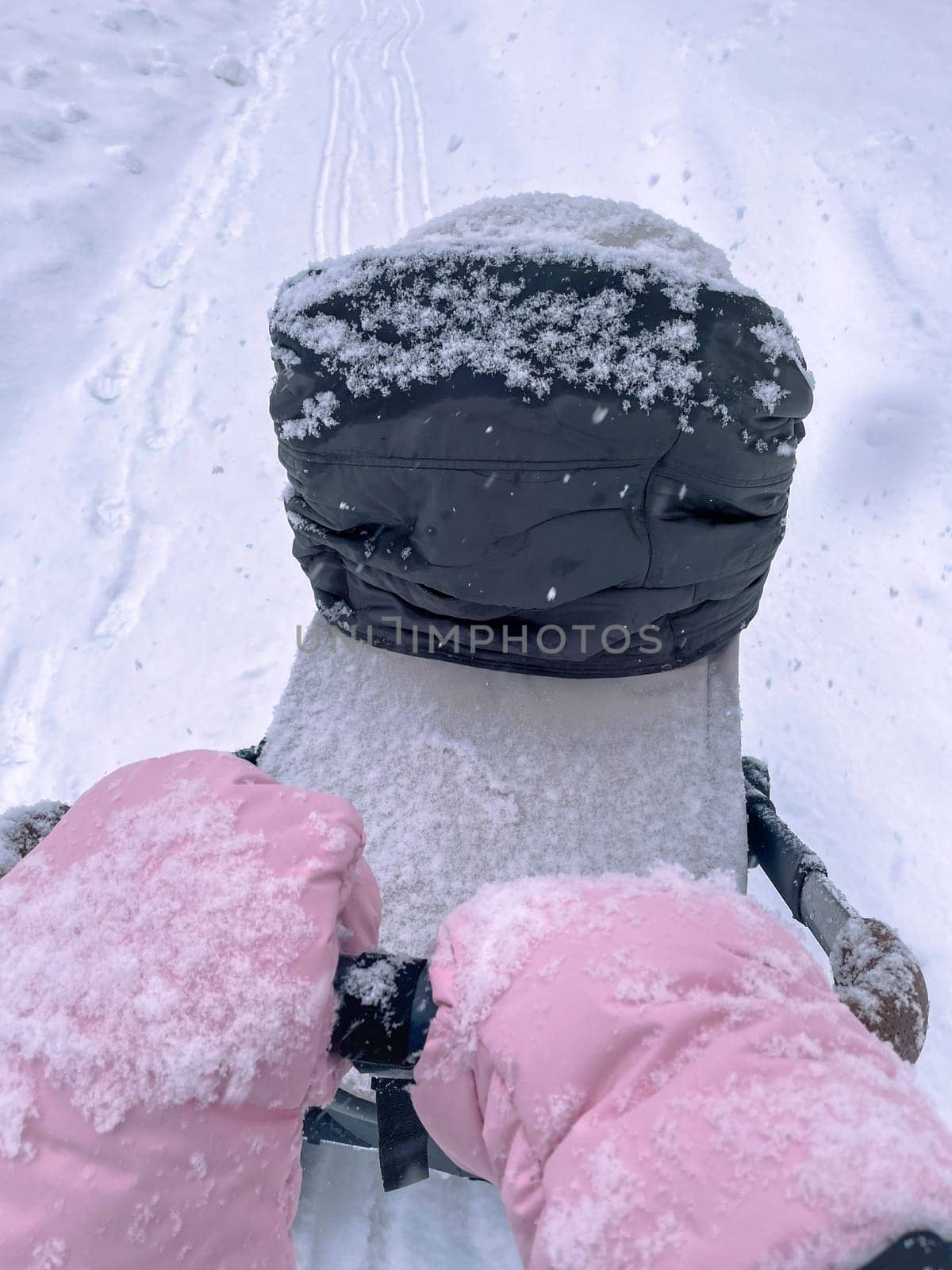 Father leading the way during a serene winter walk, blanketed in freshly fallen snow. Vertical photo by darksoul72