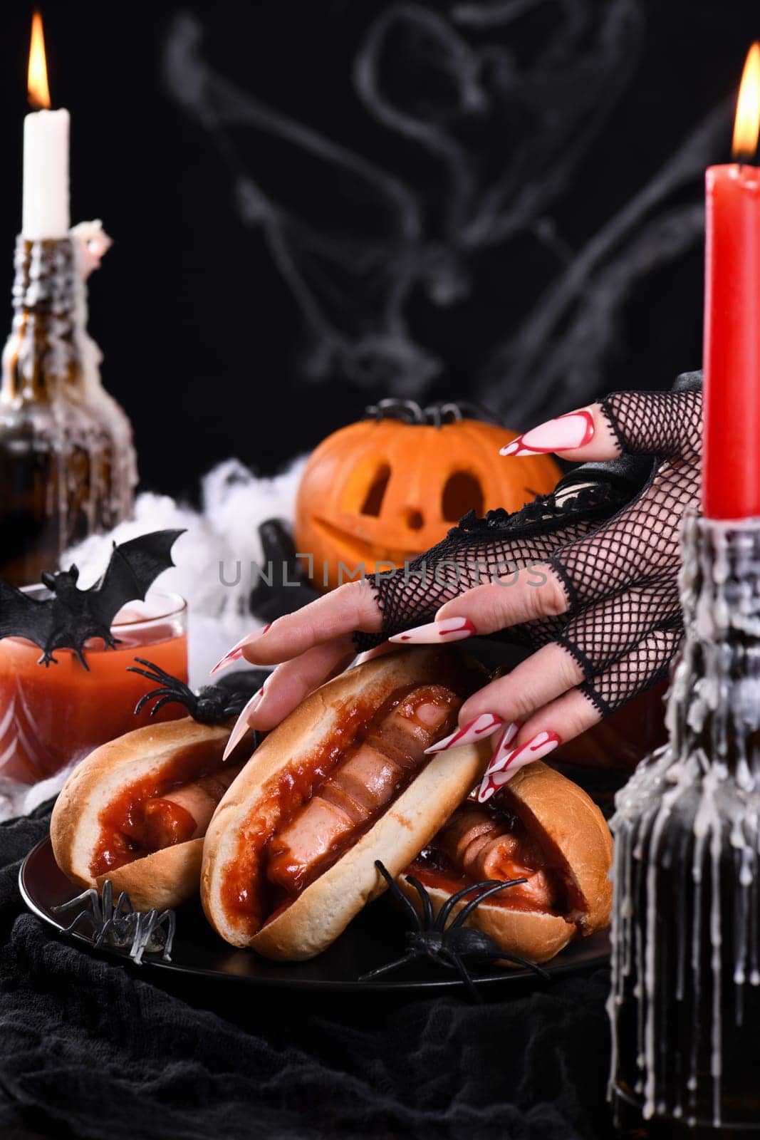  Hot dog Bloody fingers in the hands of a witch. Halloween appetizer