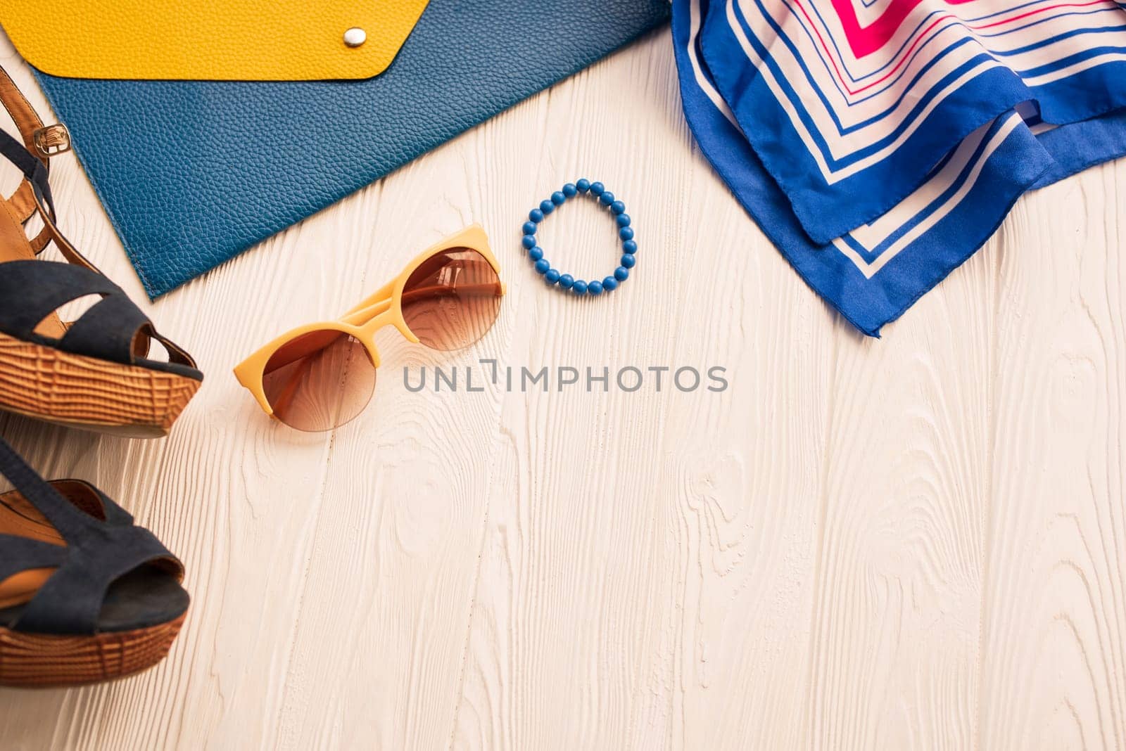 Sunglasses bijouterie jewelry bracelets clutch bag wedges shoes. Summer background mockup. top view above white wooden background Summer fashion accessories beach. Women summer design Vacation concept