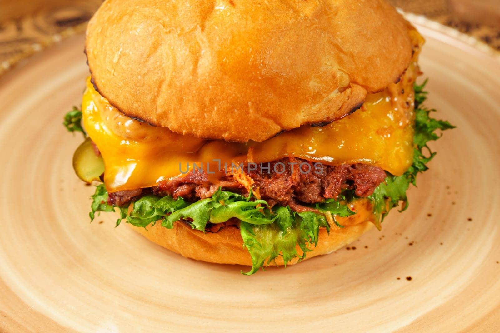 Delicious Cheeseburger With Lettuce and Toppings on Plate