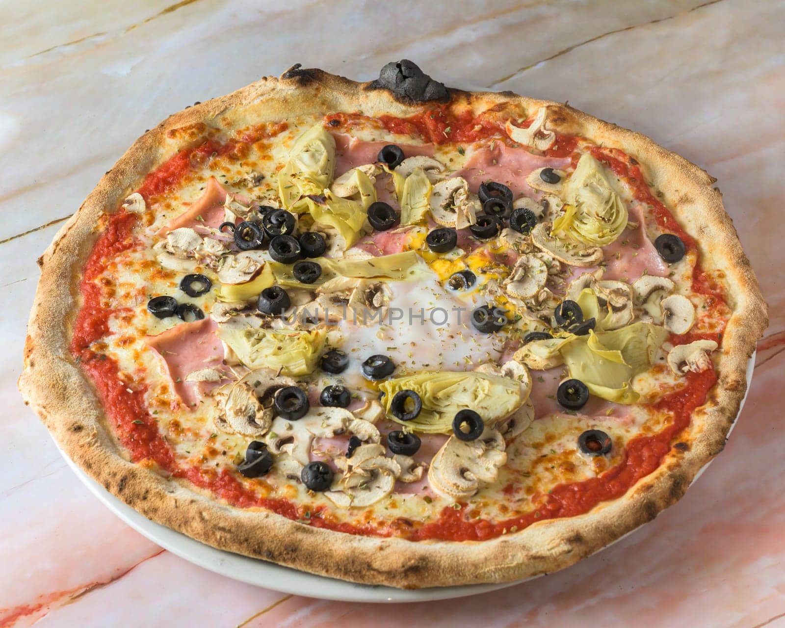 Capricciosa pizza with cheese, bacon, tomatoes, mushrooms and basil, italian meal. Baked neapolitan pizza with artichokes served on marble board.,