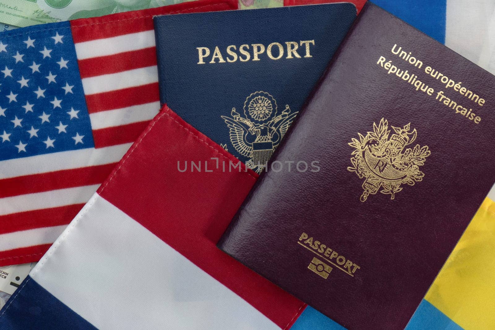 United States and France passports on Euro currency and French, American, Russian and Ukraine flags by bRollGO